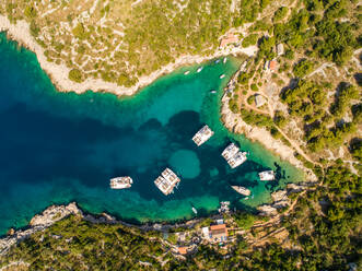 Aerial view above of luxury yachts anchored on the shore of the bay, Tatinja, Croatia. - AAEF07904