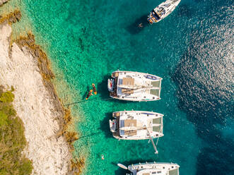 Aerial view of luxury yachts in bay off Hvar island, Croatia. - AAEF07923