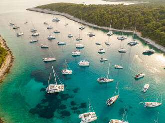 Aerial view of many luxury boats anchored at Vinogradisce bay, Hvar island, Croatia. - AAEF07924