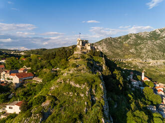 Aerial view of the Klis Fortress over a mountain in Klis, Croatia. - AAEF07948