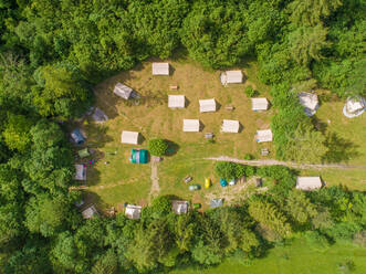 Aerial view of camping houses in the middle of the forest in the Soca valley, near Bovec, Slovenia. - AAEF07951