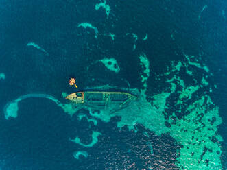 Aerial view of group of kayaks above shipwreck underwater in Veli Rat bay, Dugi Otok island, Croatia. - AAEF07964