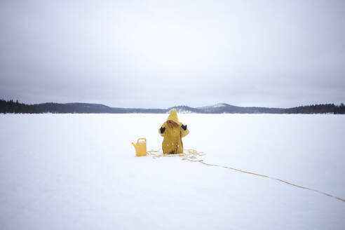 Woman Wearing Yellow Hood Stuck In Snow - EYF02102