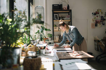 Woman Working At Desk In Workshop - EYF02151