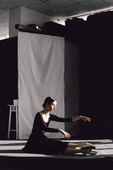 Female Ballet Dancer Sitting On Stage - EYF02222