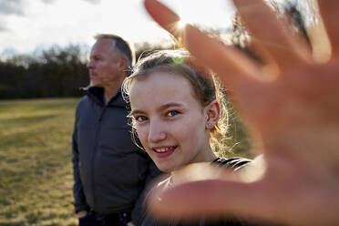 Portrait of smiling girl with her father on a meadow - AUF00283