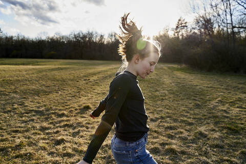 Happy girl dancing on a meadow stock photo