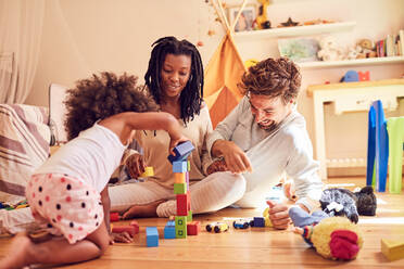 Young family playing with wood blocks - CAIF25496