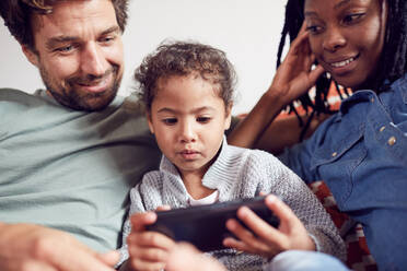 Young family using smart phone - CAIF25516