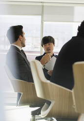 Businessmen talking in conference room meeting - CAIF25603