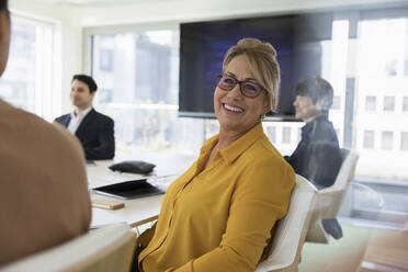 Portrait smiling, confident businesswoman in conference room meeting - CAIF25607