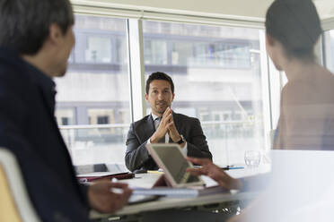 Businessman talking in conference room meeting - CAIF25641