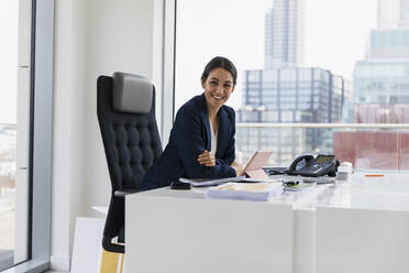 Portrait confident businesswoman working in urban office - CAIF25663