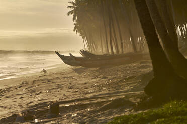 Ghana, Keta, Boats left on coastal beach at dusk - VEGF01850