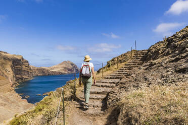 Portugal, Madeira, Female hiker walking up coastal steps at Ponta de Sao Lourenco - WDF05892