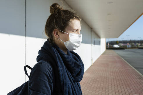 Portrait of woman wearing mask at an empty street - OJF00370