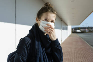 Portrait of woman wearing mask at an empty street - OJF00371