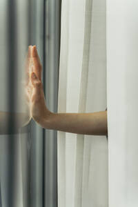 Hand of a woman touching windowpane - AFVF05959
