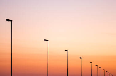 Low Angle View Of Street Lights Against Sky During Sunset - EYF02371