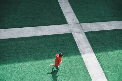 High Angle View Of Boy Running On Stadium - EYF02453