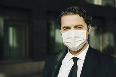 Portrait of businessman with face mask - MASF17319