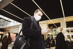 Man walkin in street wearing face mask - MASF17347