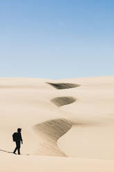 Man Walking In Desert Against Clear Sky - EYF02554