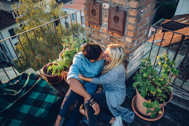 High Angle View Of Couple Kissing In Balcony - EYF02568