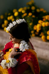 High Angle View Of Bride Wearing Flowers While Standing Outdoors - EYF02598