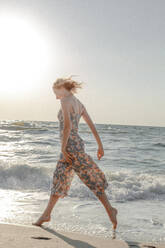 Woman Wading In Sea Against Clear Sky - EYF02708