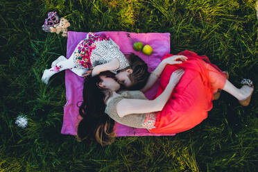 Portrait Of Mother And Daughter On Grassy Field - EYF02785