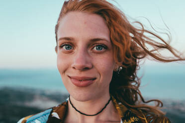 Portrait Of Smiling Woman Standing Outdoors - EYF02990