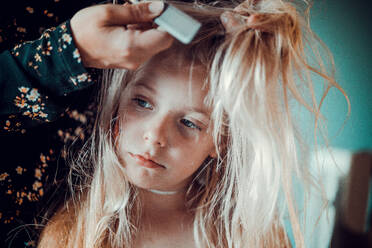 Midsection Of Mother Combing Daughter Hair At Home - EYF03058