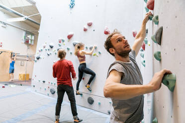 Sporty Man Dressed In Rock Climbing Outfit Training In Bouldering Gym Stock  Photo, Picture and Royalty Free Image. Image 106757811.