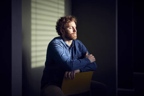 Relaxed casual businessman sitting down with closed eyes - RBF07234