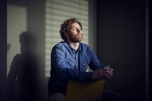 Relaxed casual businessman sitting down with closed eyes - RBF07236