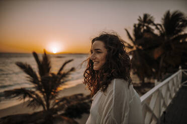 Woman enjoying sunrise at the sea - DAWF01335