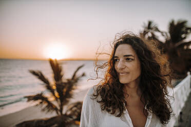 Woman enjoying sunrise at the sea - DAWF01338