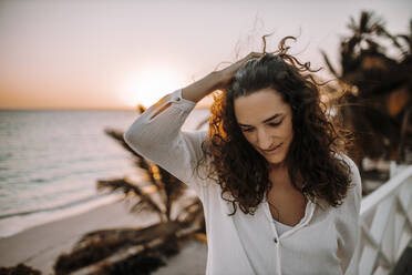 Woman enjoying sunrise at the sea - DAWF01339