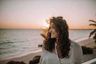 Woman enjoying sunrise at the sea - DAWF01342