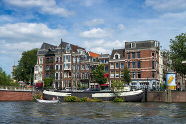 The Netherlands, North Holland Province, Amsterdam, Old town buildings at Amstel river - LBF03020