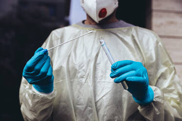 Healthcare worker holding swab test kit for PCR testing - MFF05399