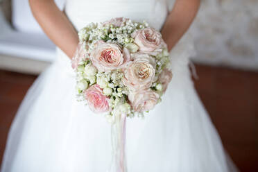 Midsection Of Bride Holding Flower Bouquet - EYF03304