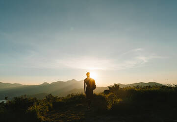 Silhouette Man Standing On Field Against Sky During Sunset - EYF03306