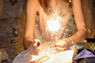 Midsection Of Woman With Sparkler - EYF03331