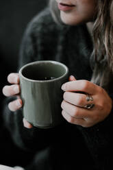 Midsection Of Young Woman Holding Coffee Cup - EYF03410