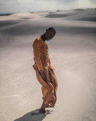 Full Length Portrait Of Young Man Wearing Traditional Clothing Standing At Desert - EYF03695