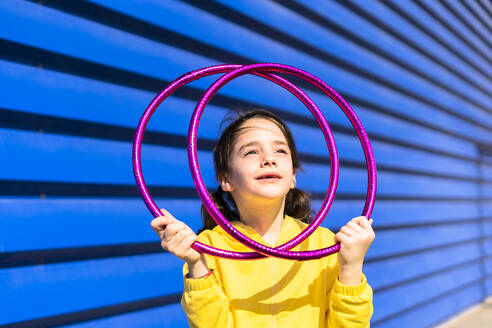 Portrait of little girl with gymnastic rings looking up - ERRF03254