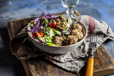 Bowl of ready-to-eat salad with spinach falafel - SBDF04243