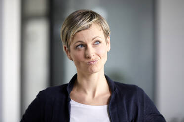 Portrait of a pensive businesswoman in office - RBF07407